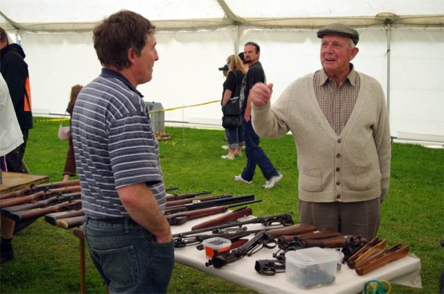 Dad discusses rifles with a vendor at Armistice in Cambridge